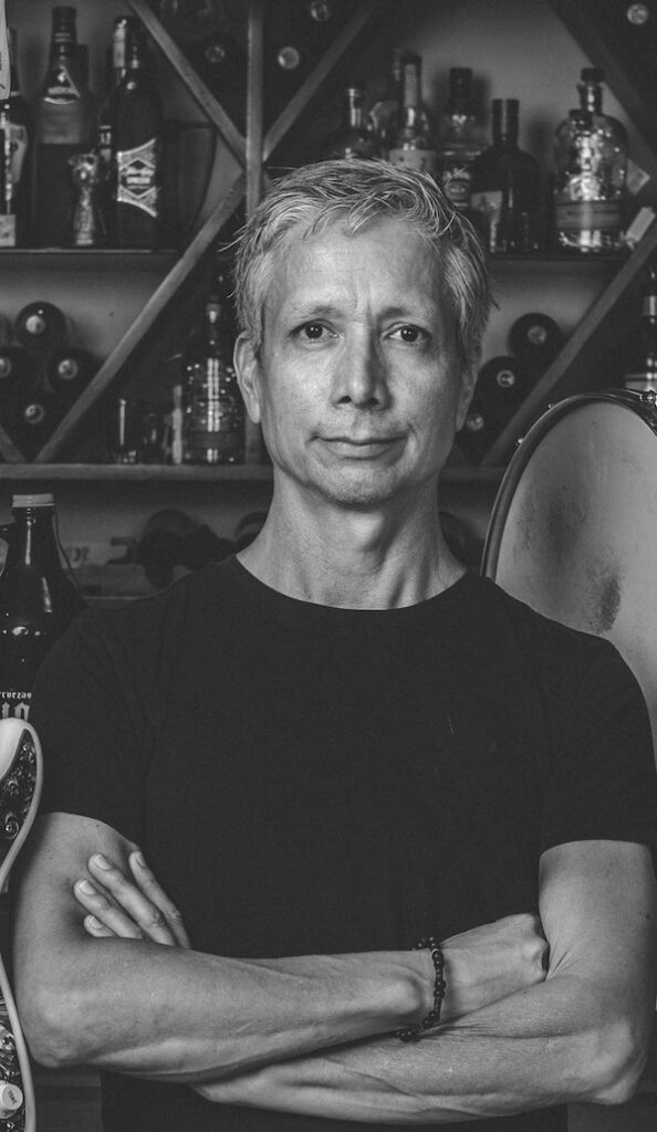 Robonzo wearing black tee with arms crossed (black & white)